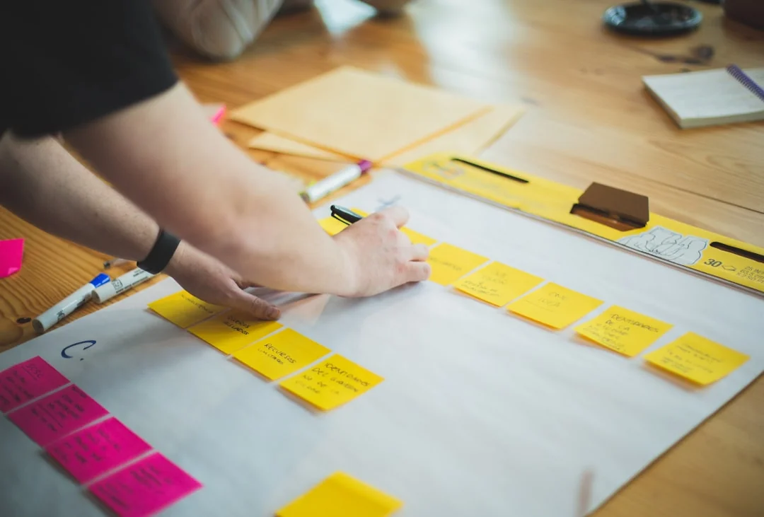 Sticky notes with holiday marketing ideas clipped to a wall grid.